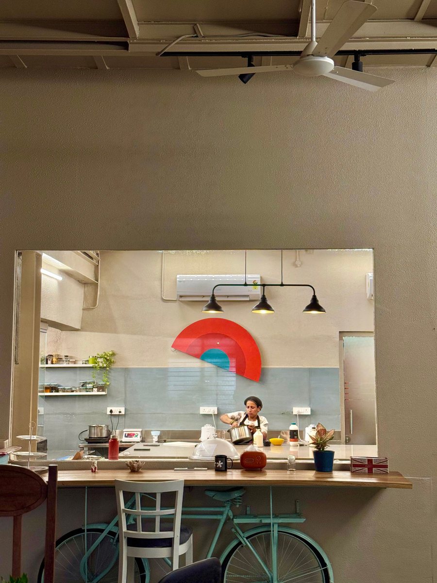 The open kitchen at Gather with the Break of Dawn sunrise on the wall