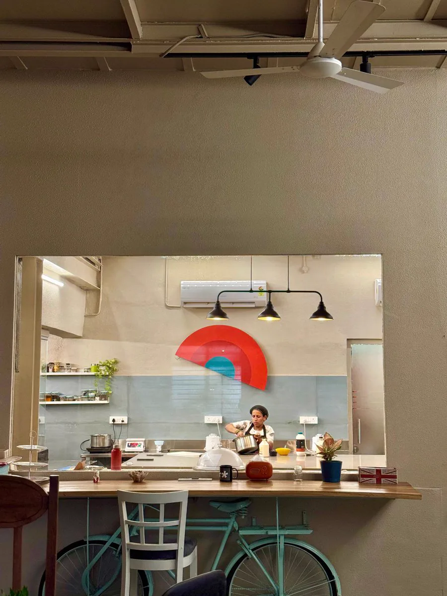 The open kitchen at Gather with the Break of Dawn sunrise on the wall