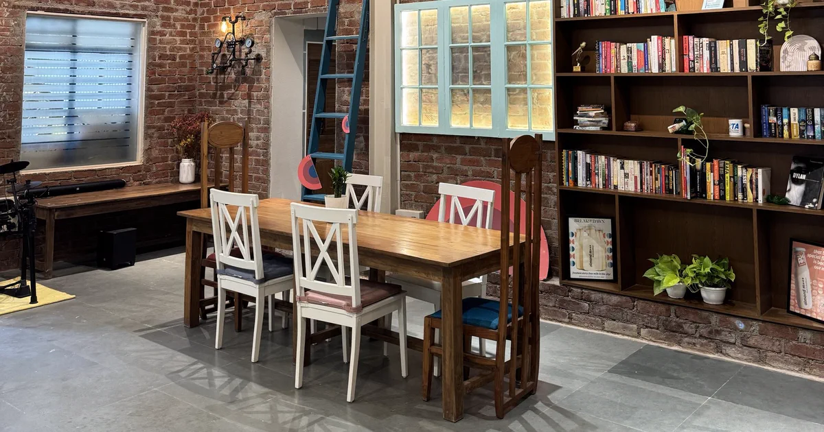 The Gather website, showing the studio's long table, bookshelves and brick walls in daylight