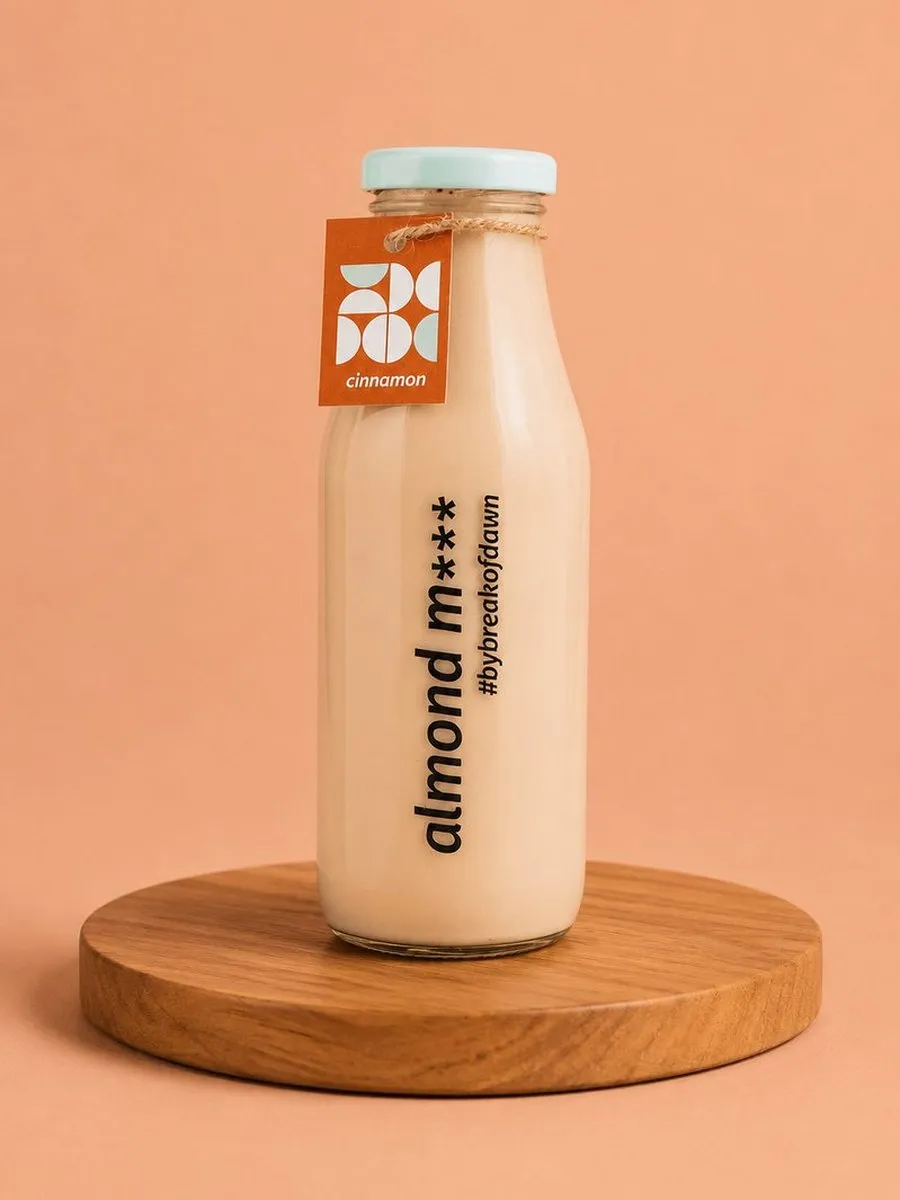 A glass bottle of Break of Dawn cinnamon almond milk, made fresh in Mumbai