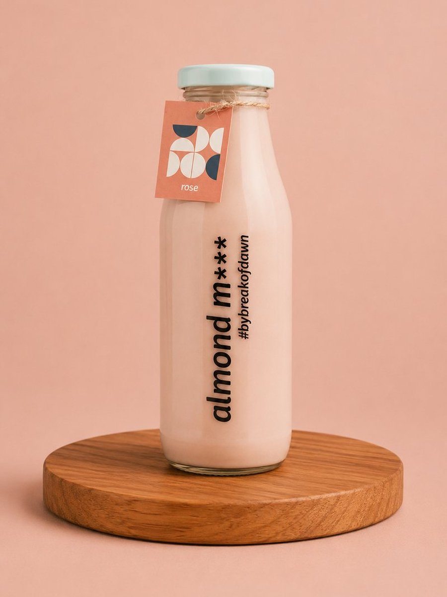 A glass bottle of Break of Dawn rose almond milk, made fresh in Mumbai