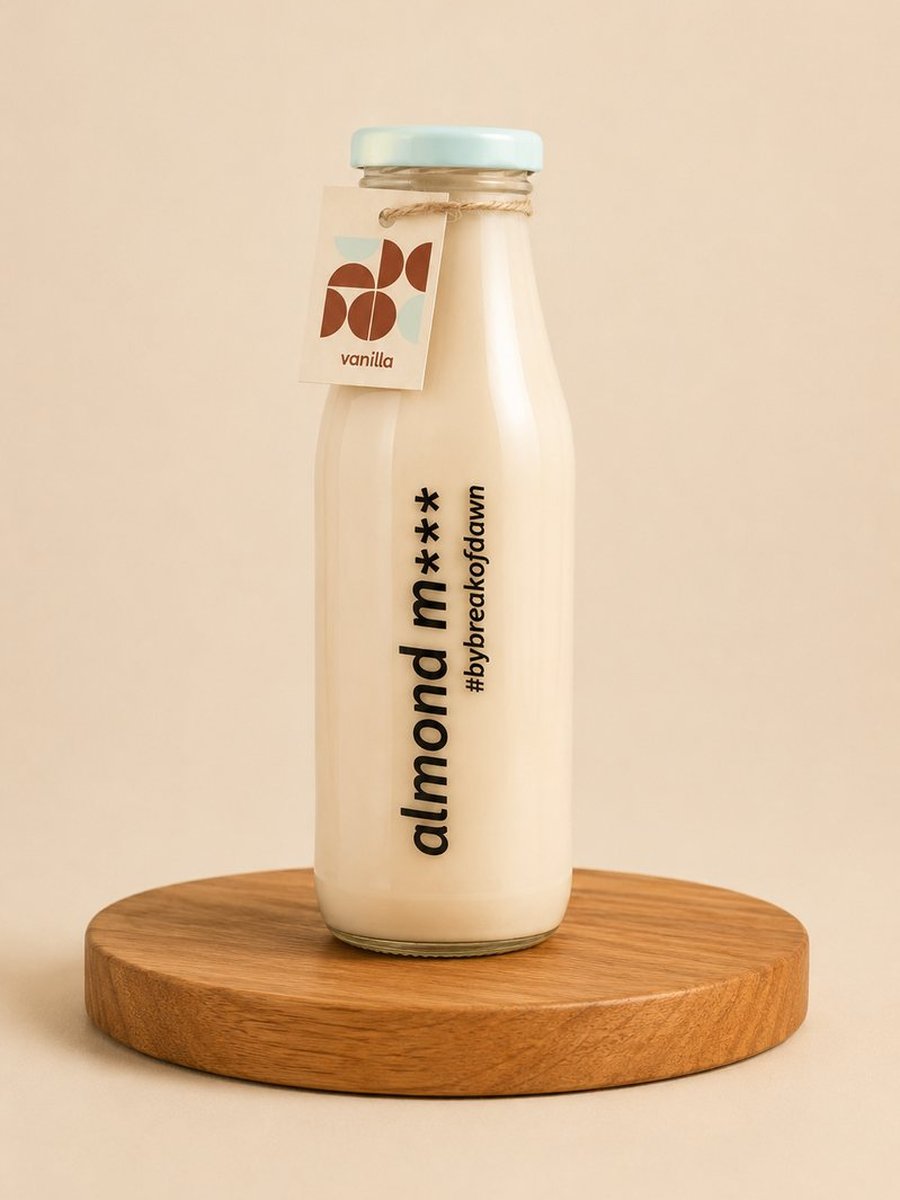A glass bottle of Break of Dawn vanilla almond milk, made fresh in Mumbai