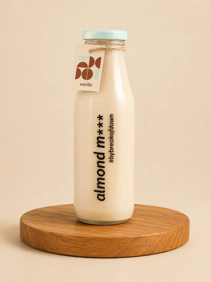 A glass bottle of Break of Dawn vanilla almond milk, made fresh in Mumbai