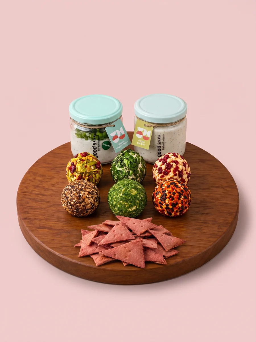 The Spread bundle from Break of Dawn on a wooden board: six feta bombs, jalapeño cream cheese, vegan tzatziki and beetroot lavash