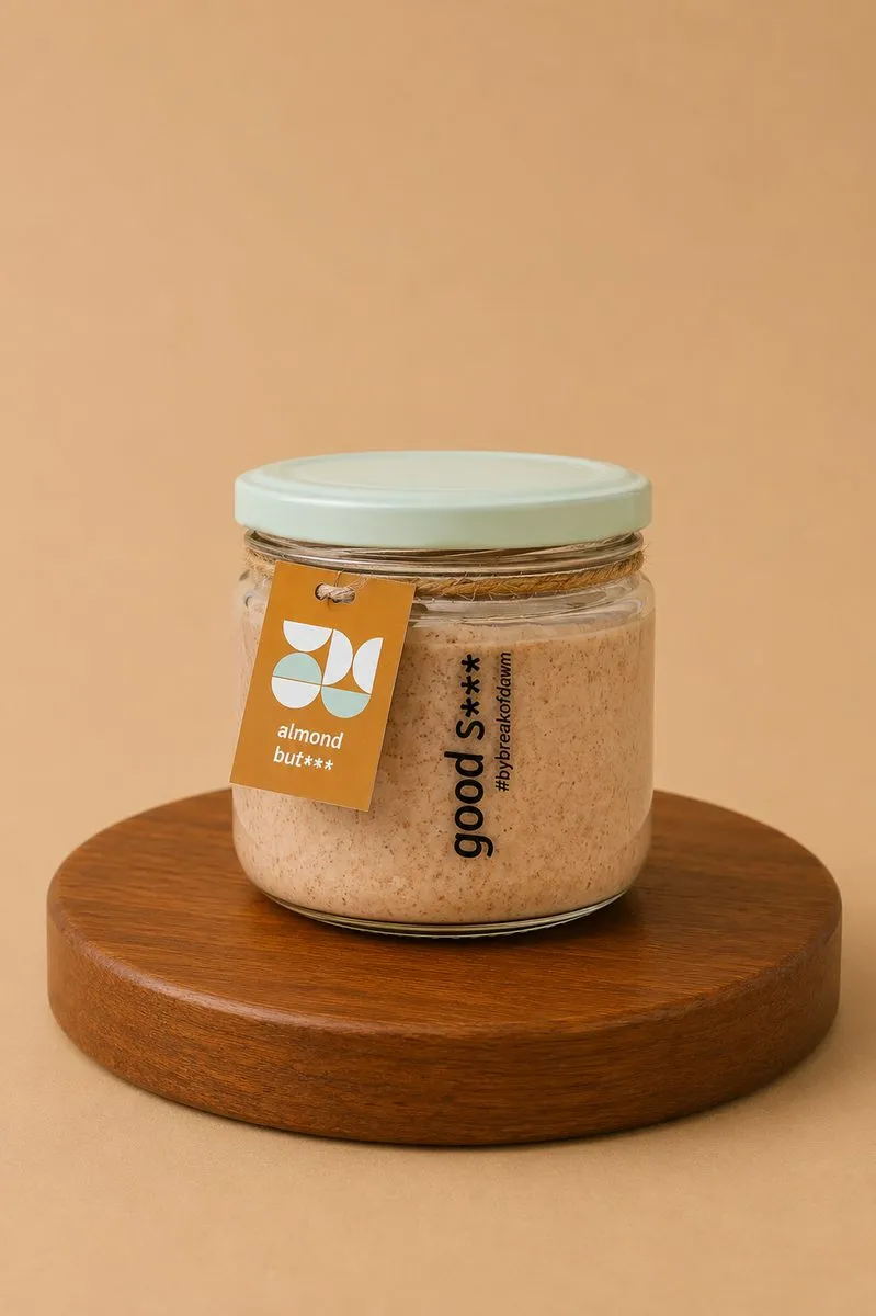 A jar of Break of Dawn almond butter, stone-ground with 29.5 g protein per 100 g