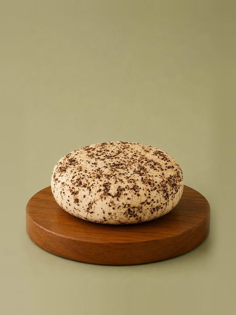 A wheel of Break of Dawn peppercorn feta, nut-based feta made from almonds