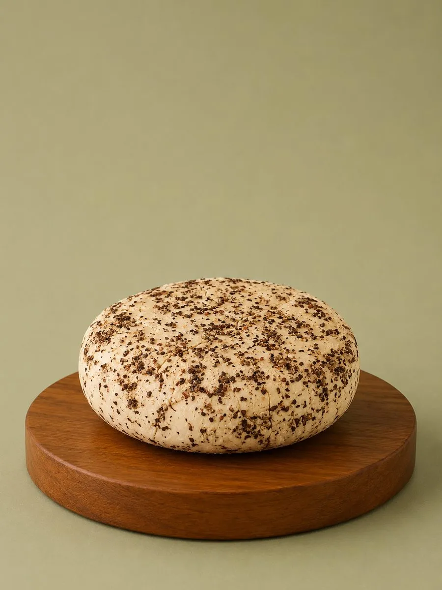 A wheel of Break of Dawn peppercorn feta, cultured nut-based feta made from almonds