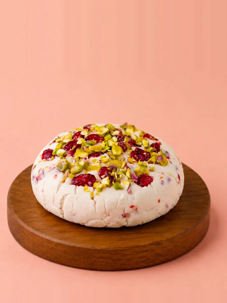 A wheel of Break of Dawn cranberry & pistachio feta, cultured nut-based feta made from almonds