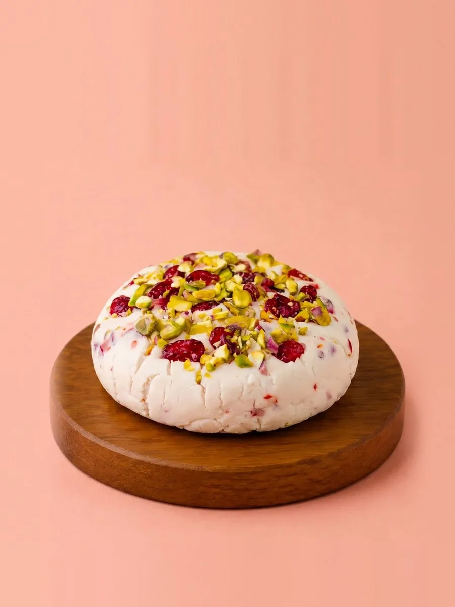 A wheel of Break of Dawn cranberry & pistachio feta, nut-based feta made from almonds
